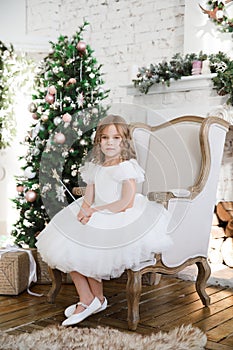 Girl with magic wands sitting in chair. Christmas