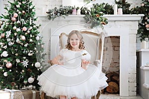 Girl with magic wands sitting in chair. Christmas