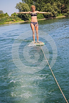 Girl maintining balance on a surfboard