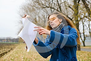 Girl make ritual with burning paper outdoors