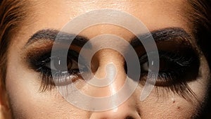 Girl with make up, face creams are made up and beautiful brown eyes. Close up