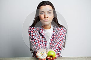 Girl makes a choice between healthy and harmful food