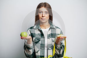 Girl makes a choice between healthy and harmful food