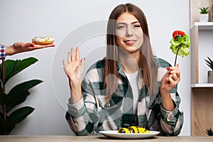 Girl makes a choice between healthy and harmful food
