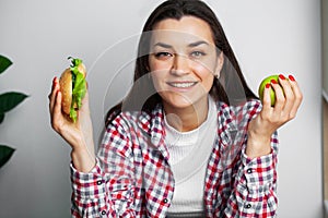 Girl makes a choice between healthy and harmful food