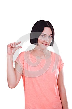 A girl makes a hand gesture a little bit on a white isolated background