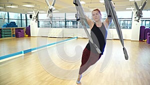 Girl makes sagging on a hammock to fly yoga