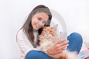 The girl makes selfie with cat