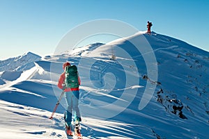 Girl makes ski mountaineering alone toward the mountain pass in a nice track with sealskin