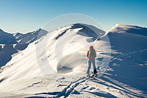 Girl makes ski mountaineering alone toward the mountain pass in a nice track with sealskin