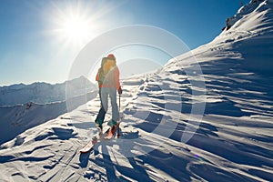 Girl makes ski mountaineering alone toward the mountain pass in a nice track with sealskin