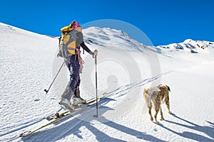 Girl makes ski mountaineering with dog