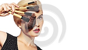 Girl with Makeup Beauty Brushes. Fashion Make-up for Sexy Woman. Make-up Artist Applying Visage on white background