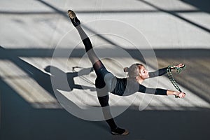 Girl making balance rope. rhythmic gymnastics.