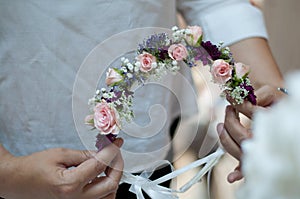 Girl Making a Beautiful Wedding Flower Crown with Pink Roses