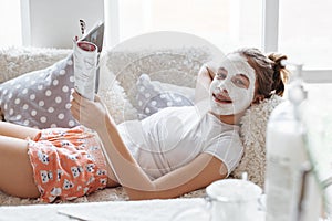 Girl making clay facial mask