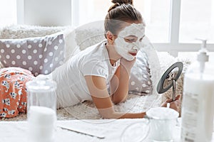 Girl making clay facial mask