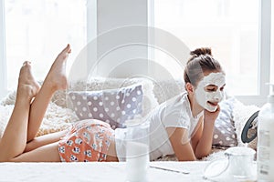 Girl making clay facial mask