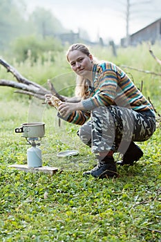 Girl making coffee on gas burner