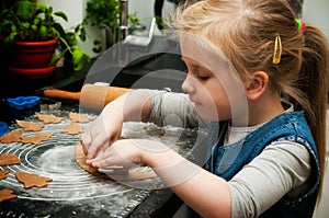 Girl making gingerbread cookies for Christmas