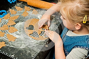 Girl making gingerbread cookies for Christmas