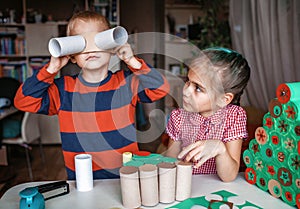 Girl making handmade advent calendar with toilet paper rolls at home. Seasonal activity for kids