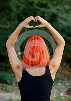 Girl making a heart shape symbol