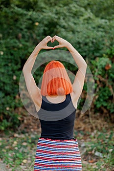 Girl making a heart shape symbol