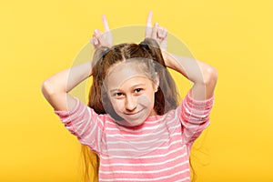 Girl making horns hands childish behavior