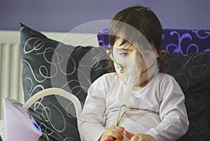 Girl making inhalation with mask on her face