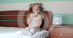 Girl making inhalation with nebulizer at home.