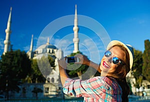 Girl making photo by the smartphone near the Blue Mosque, Istanbul. Turkey