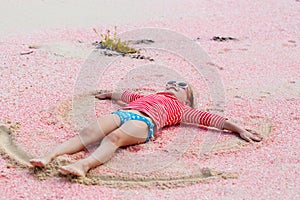 Girl making sand angel