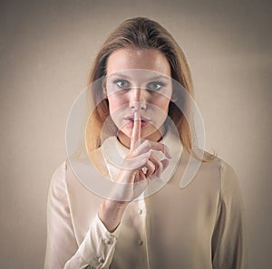 Girl making the silence gesture