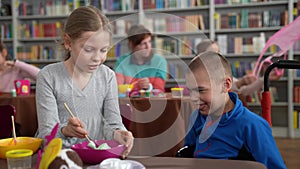 Girl making slime for brother with cerebral palsy