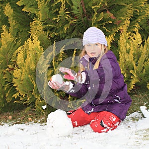 Girl making snow ball