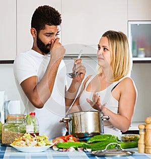 Girl and man smelling foul food
