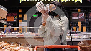 Girl in a mask has shopping in the supermarket