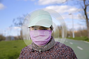 Girl with a mask on her face in the park