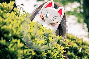 The girl in the mask kitsune in Tokyo