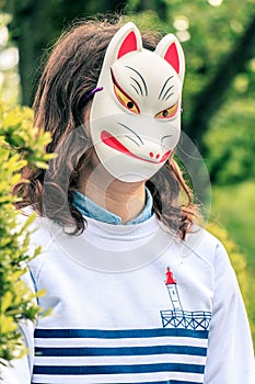The girl in the mask kitsune in Tokyo