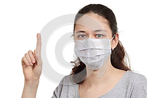 A girl in a mask shows a stop gesture fearing for the health of people