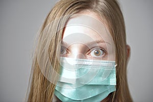 Girl with mask to protect her from Corona virus. Corona virus pandemic. Corona written on mask