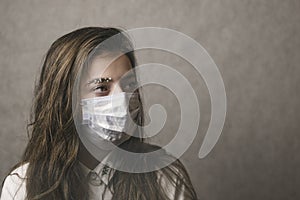 A girl with a mask to protect her from the coronavirus. The mask on the girl`s face. Mask on the eyes