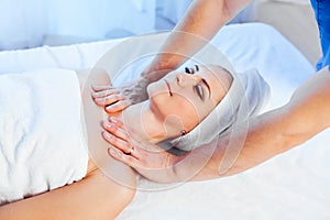 Girl masseur doing massage neck face spa health