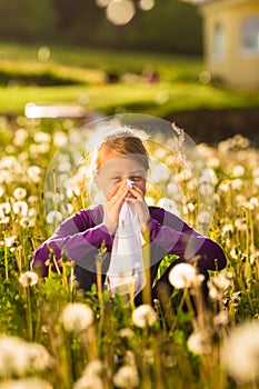 Girl in meadow and has hay fever or allergy