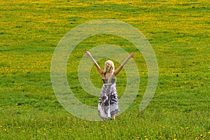 Girl on meadow in spring, arms