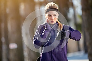 Girl measure pulse on cardio training outdoor