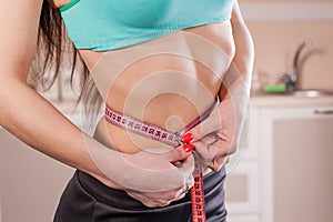 Girl measuring her waist