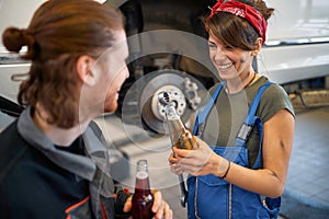 Girl mechanic on a break with male colleague